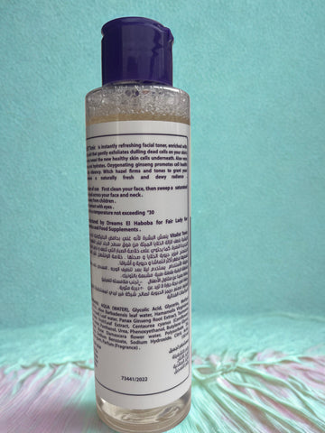 Bottle of facial toner with a purple cap on a light blue background label